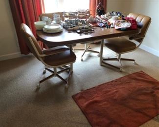 Vintage kitchen table with chairs on casters, seat need new upholstery. 