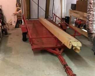 single axel lawn mower trailer with drop down ramp, also shown is a square porch post with caps