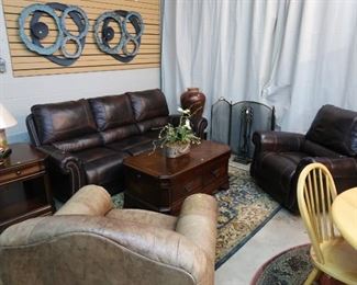 Brown leather reclining sofa and matching swivel chair