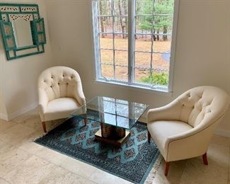 Two arm chairs - and blue and black Bokhara rug.