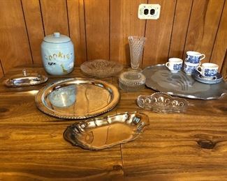 This table shows silver plated trays, cut glass pieces, an antique cookie jar, and a set of 4 plates and 4 cups and saucers in a Churchhill pattern Staffordshire, England