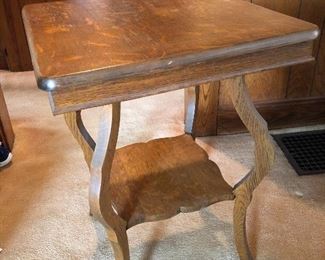 The 19” square oak table has two levels and is in great condition.