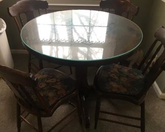 wooden table with checkerboard design & glass top, & 4 wooden chairs