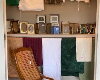 Table cloths, picture frames and wicker rocking chair