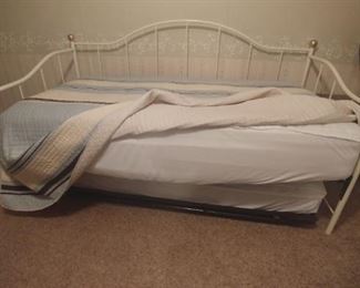 Daybed showing popup trundle with mattress. Makes a king size bed with trundle is popped up.