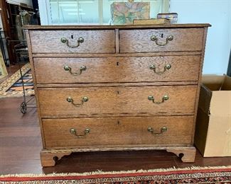 George III Oak Five Drawer Chest.  Originally with bail side handles, now plugged and removed.  Projecting top with molded edge: brass bail drawer handles.  H: 34.5" W: 39" D: 18 7/8.  $1600