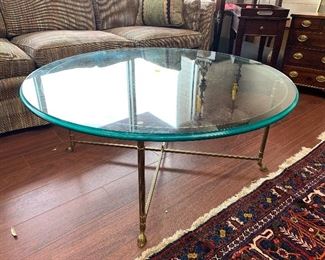 Straight out of the Ballard Designs catalog. Round glass and brass base coffee table.  Glass is 42 " diameter with a beveled edge.  $195