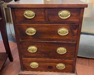 Antique 5 drawer small side cabinet with brass handles.  $395