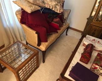 One of two petite antique settees, marble coffee/cocktail table, etc. Loads of decorative pillows, too.