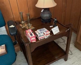 wooden end table , brass candlesticks