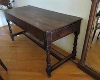 : 17th century European oak, plank top, turned legs, center stretcher support. 2 end drawers. 27” x 63.5” x 30” 