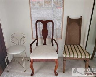 One metal chair, wooden chair with arm rests, one wicker back chair.