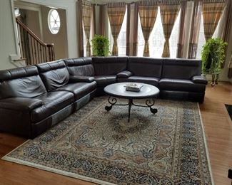 Great room: leather, reclining sectional sofa, coffee table and area rug. Sofa is approximately 9' x 9'.  Leather sofa: $1,400.00.   Rug is SOLD
