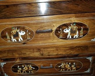 Master Bedroom: large dresser/cabinet: carved & bone colored inlaid w/ elephant scenes. #8.  With glass on top. 7 drawers. From India.  Dresser #8 (elephants): $425.00. 95" long x 23" deep x 30" tall
