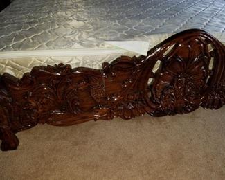 bed footboard detail. Bedroom #2: ornate wooden carved flowers King bed frame with mattress.    Bed with mattress: 195.00