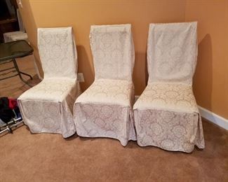 6 wooden chairs covered with white cloth.  6 covered chairs: $60.00