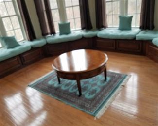 Sunroom-round  coffee table w/ drawers with  cushions for window seats.  Round Table: $45.00.  Cushions: make offer.  Table is 40" across and normal coffee table height