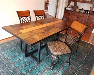 Kitchen-colored tile top dining table w/ metal legs/base and  upholstered chairs. Table w/ chairs: $100.00.  Rug is sold
