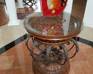Entrance: metal/carved wood table w/ glass top. 28" round x 30.5" tall.  Round table:  $65.00