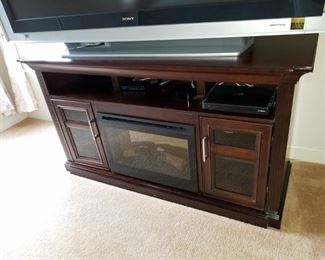 TV stand with electric fireplace.  TV STAND: $85.00.  