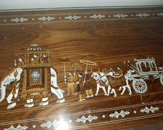 Master Bedroom: large dresser/cabinet: carved & bone colored inlaid w/ elephant scenes. #8.  With glass on top. 7 drawers. From India.     Dresser #8 (elephants): $425.00.   95" long x 23" deep x 30" tall