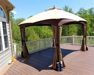 Hampton Bay outdoor canopy. 10' x 12', sides tie back/slide closed. Heavy construction w/ 4" metal poles w/ weights, hook inside for light fixture (not included), opening height is 7'. One year old!  10 ft. x 12 ft. Turnberry Outdoor Patio Gazebo with Mosquito Netting and Private Curtain.     $175.00