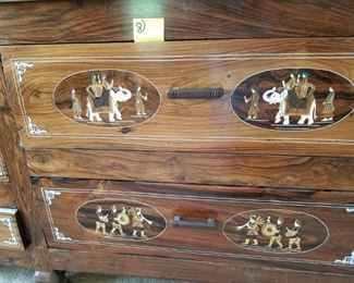 Master Bedroom: large dresser/cabinet: carved & bone colored inlaid w/ elephant scenes. #8.  With glass on top. 7 drawers. From India.   Dresser #8 (elephants): $425.00.  95" long x 23" deep x 30" tall