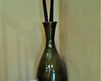 Large decorative green vase and bamboo sticks