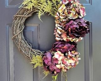 One of a pair of matching wreaths with purple flowers