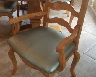 Captain's chair detail. Table has a leaf on each end which extends to create more seating. Table is 42" wide and each leaf extends 18"