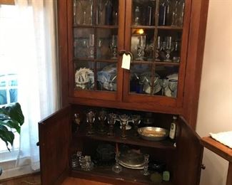 Beautiful walnut corner china cabinet with original glass and made with wooden pegs. Needs a 37" corner. $1,200