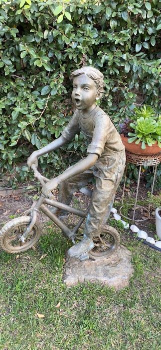 Bronze boy on bike 