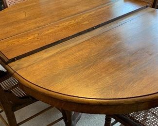 #2	Antique dining table with 4 cane chairs, 3 leaves and pads 48"-78"x48"x28"	 $150.00 
SOLD
