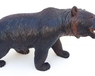 Black Forest Carving 2 of 20 Bear. Carved wood with glass inset eyes. Painted mouth. Warm patina. 6.6 x 12 x 4.3 inches. Provenance: This German Austrian Swiss Bavarian Alpine figural carving is one of twenty in the sale from the estate of a New England lifetime collector national business owner retired to central Florida.