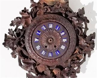 Black Forest Carving 11 of 20, dog, fox or wolf cartel wall clock, glass eyes, 26.3 x 18.5 x 6 inches deep, dial 7.3 inches diameter, rear interior compartment 14 x 9.8 inches at widest point. numbered 2236 in old ink script in the interior. Provenance: This German Austrian Swiss Bavarian Alpine figural carving is one of twenty in the sale from the estate of a New England lifetime collector national business owner retired to central Florida.