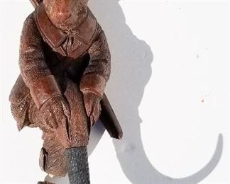 Black Forest Carving 18 of 20, hunting rabbit in a suit double hat rack coat hook, glass eyes, 13 x 6.5 x 4 inches overall. Provenance: This German Austrian Swiss Bavarian Alpine figural carving is one of twenty in the sale from the estate of a New England lifetime collector national business owner retired to central Florida.