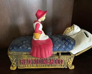 ITEM #64 Cast iron reproduction heavy vintage Little Red Riding Hood mechanical bank by Bits & Pieces.  Insert a coin and when the lever is pulled, the head of grandma lifts and reveals the big bad wolf face, $65