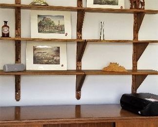 #53 Teak console/dresser/storage unit that matches the other furniture in the home $475.  Open the doors there are lots of drawers.                                                                                         Prints are sold. Teak Shelving above not for sale.