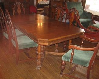 #27-$1200. Double pedestal dining table with 2 leaves and 6 chairs (1 armchair)-6'-8'L x 4'W x 29-1/2"H