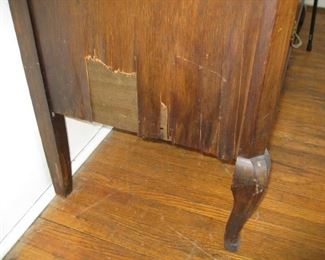 detail of damaged veneer on small dresser