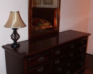 2nd View: Dixie Cherry 10-Drawer Dresser 34.5”H x 66”W x 19.5”D) with Center Finial Broken Arch Beveled Mirror(47.5”H x 31.5”W)
