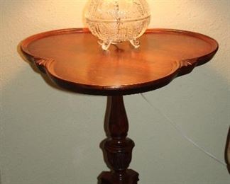 Vintage Mahogany Clover Shape Pie Crust Edge Occasional Pedestal Tables on 3 Splayed Legs. 26.5”H x 21”D. (1 of 2 shown) Also shown is a small Crystal Vanity Lamp