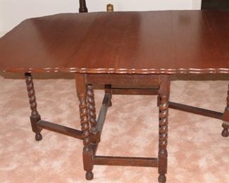 Lovely old spindle gate legged, pie crust top table. It is in nice condition with only minor wear and scuffs. It measures 58 inches long unfolded and measures 20 inches when folded. It measures 40 inches wide. $225.00