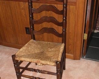Old rush seat ladder back chair. Sturdy, but has wear. It measures 18 inches wide and 44 inches tall. $25.00