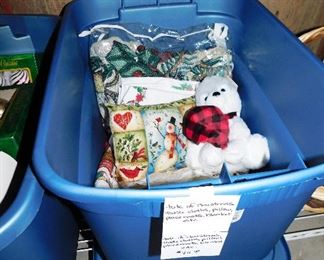 Tub full  of Christmas tablecloths, throw, pillow, placemats and plush dog $20