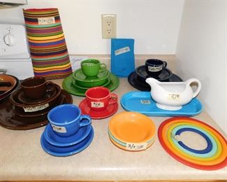 Fiesta:   Placemats SOLD     Green place setting $18.     Napkins 4/$5           Dark Blue place setting $18    Brown  place setting $18     Red cup/saucer $3.                  Blue tray SOLD         White sauce boat $10.                                Blue cup/saucer and small bowl $4.     3 bowls SOLD       5 piece rubber trivet set $6.  