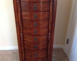 Jewelry Armoire $150 **pic 1** Antique walnut jewelry armoire has 8 drawers, 3 deep, 5 shallower, 4 divided. Side panels open for hanging longer pieces. Top lifts up for mirror, additional storage. Key included, still in original packaging.