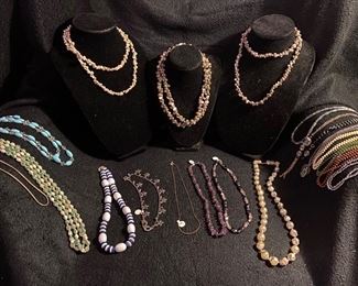 Assortment of Costume Jewelry Various Prices, Blue Glass Beads with Accent Crystal Beads Necklace $16, Blue Green Turquoise Beads Necklace $4, Blue/White $4, Magnetic Polished Stone Black and Rose Quartz $12, Ametyst Stones Necklace $10, Daisies $8, White/Silver Beaded Necklace $8, Assorted Sea Shell Necklaces