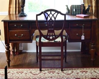 Mahogany desk on four turned legs. Drawers contain oak dividers, and a single Shield-Back side chair. Note the pair of bookeds well cast representing the Labrador breed.