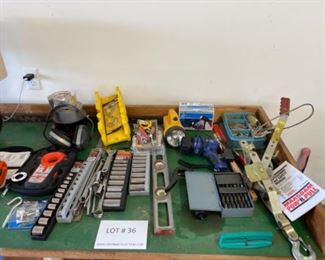 Lot of tools, stud finder , wrenches, socket sets, drill bits, flashlights, tape, levels.